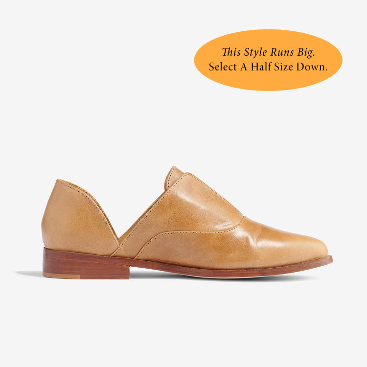 Single tan leather d'Orsay Oxford shoe with a pointed toe and low wood heel shown in profile against a white background.