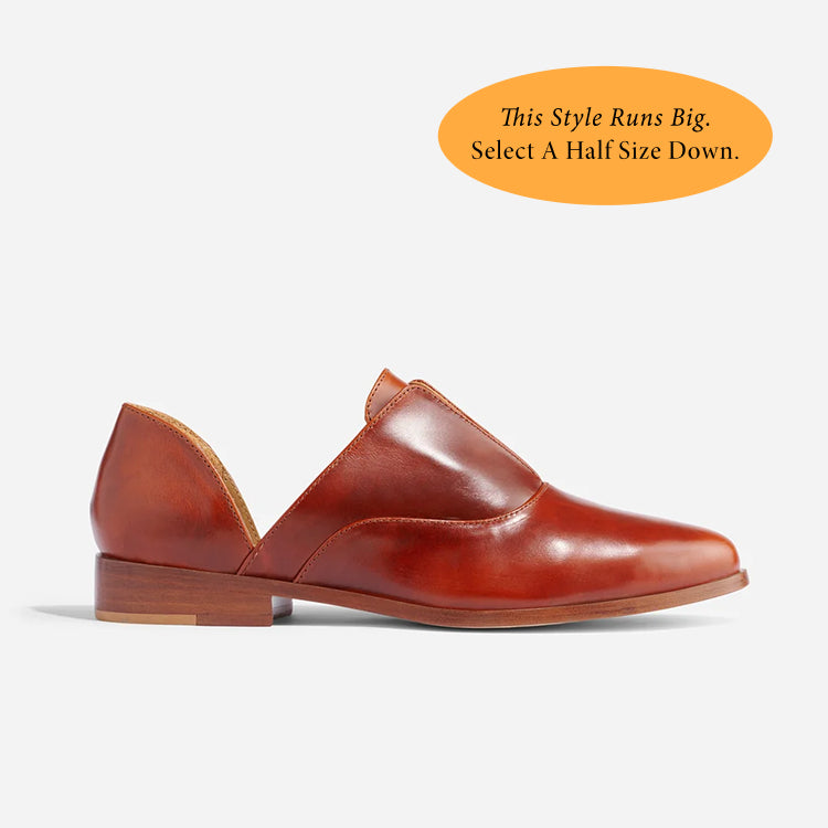 Single brandy leather d'Orsay Oxford shoe with a side cutout and low wooden heel shown in profile on a white background.